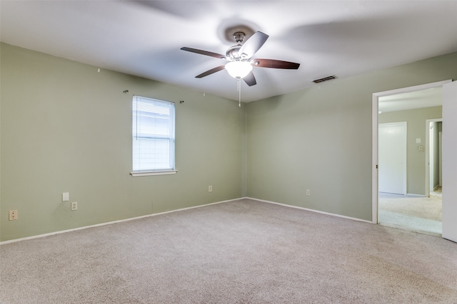 empty room with light colored carpet and ceiling fan