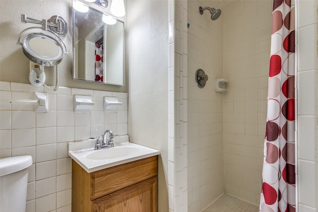 bathroom with vanity, curtained shower, and tile walls