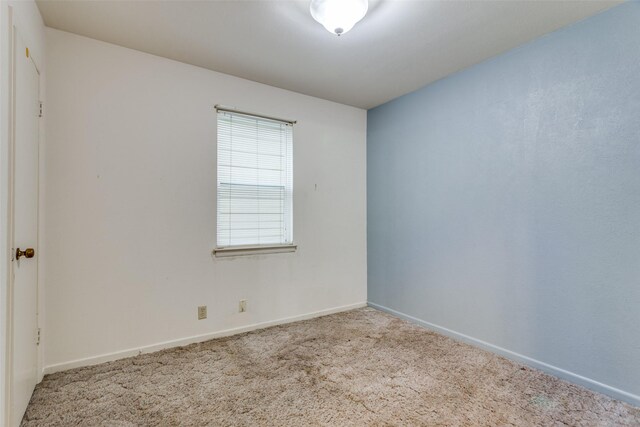 carpeted empty room with baseboards