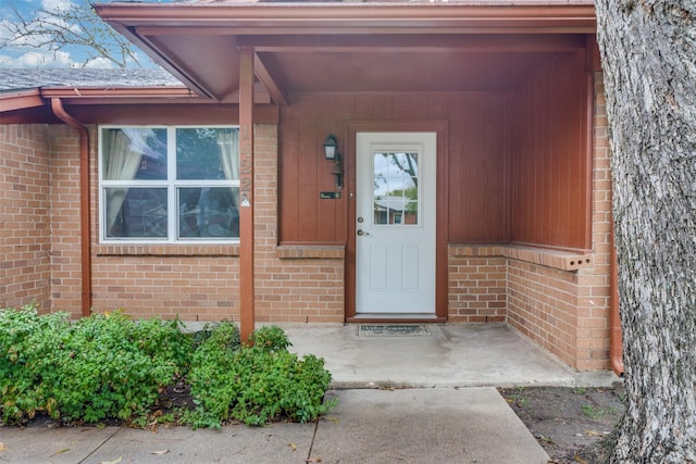 property entrance with brick siding