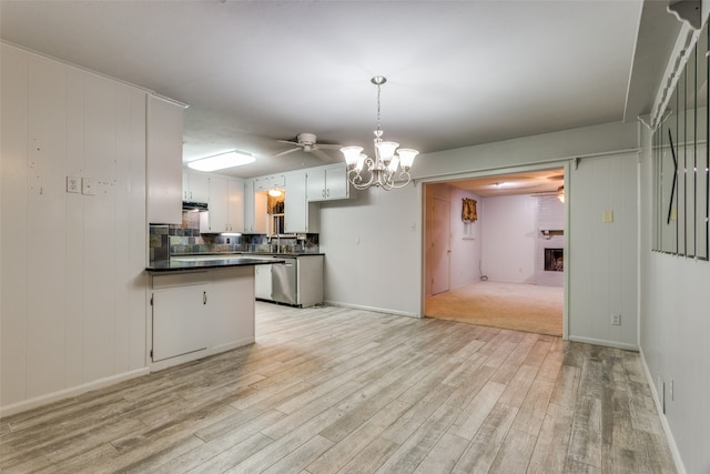 kitchen with white cabinetry, backsplash, a brick fireplace, ceiling fan, and light hardwood / wood-style flooring