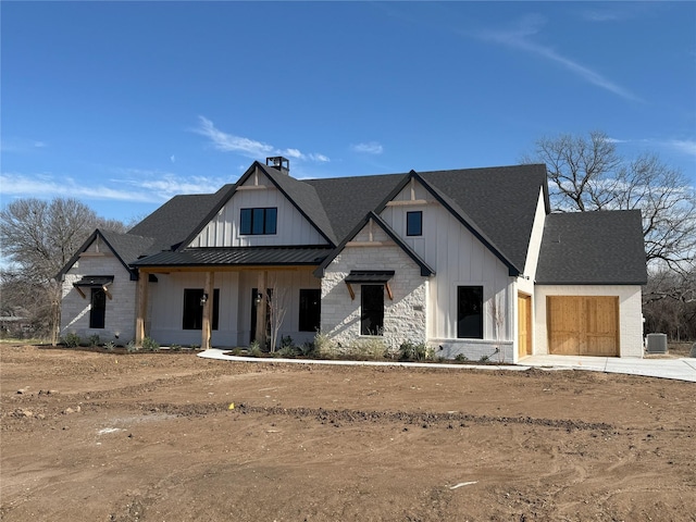 modern farmhouse style home featuring a garage and central air condition unit