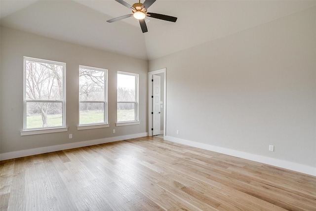 unfurnished room with baseboards, light wood-style floors, lofted ceiling, and a ceiling fan