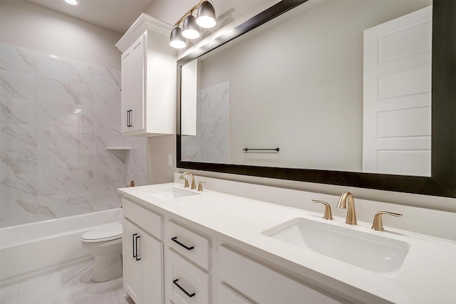 full bath featuring double vanity, marble finish floor, toilet, and a sink