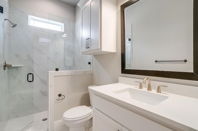 full bath with a marble finish shower, toilet, and vanity