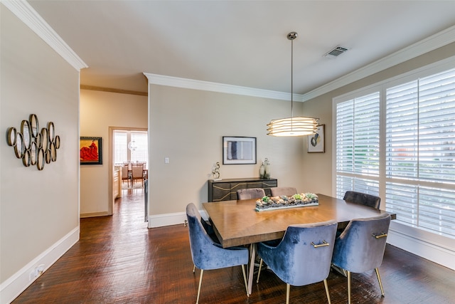 dining area featuring dark wood-type flooring and crown molding