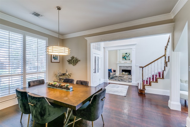 dining space with dark hardwood / wood-style floors and crown molding