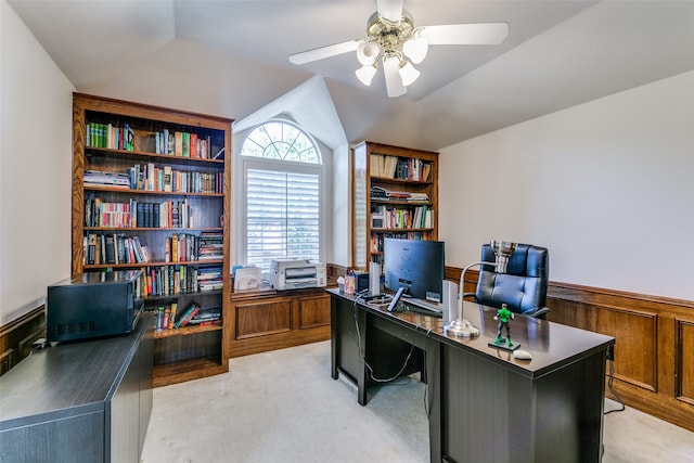 carpeted office with lofted ceiling and ceiling fan