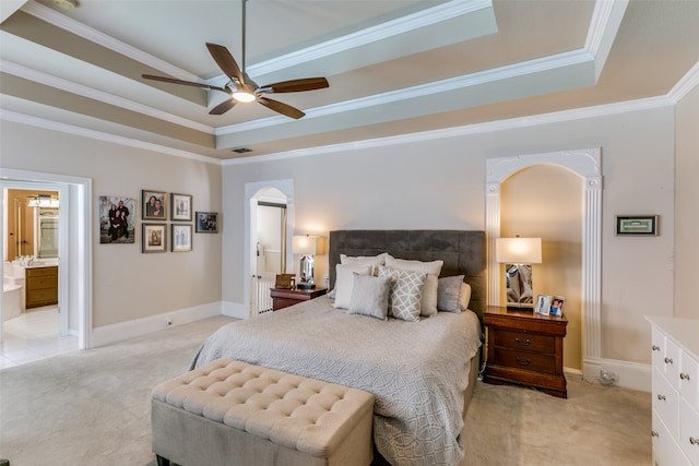 bedroom with light carpet, ceiling fan, crown molding, and a tray ceiling