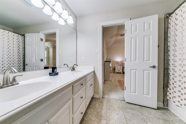 bathroom featuring vanity, shower / bath combination with curtain, and tile patterned flooring