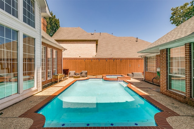 view of pool with a patio and an in ground hot tub