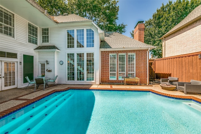 rear view of property featuring a patio and an outdoor hangout area