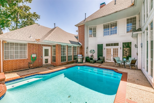 view of swimming pool with a grill and a patio