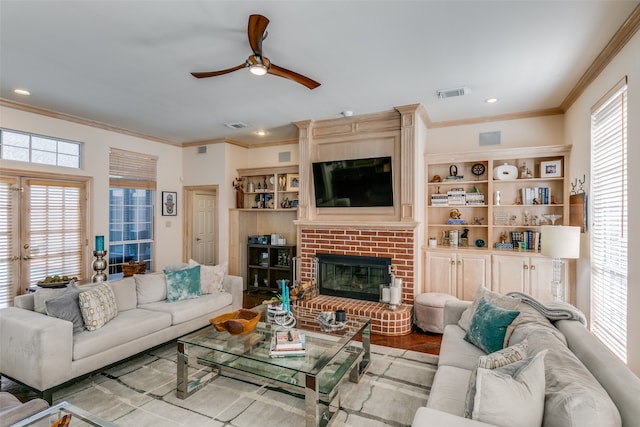 living room featuring a wealth of natural light, light hardwood / wood-style flooring, and ornamental molding