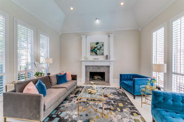 living room featuring ornamental molding, a tiled fireplace, and lofted ceiling