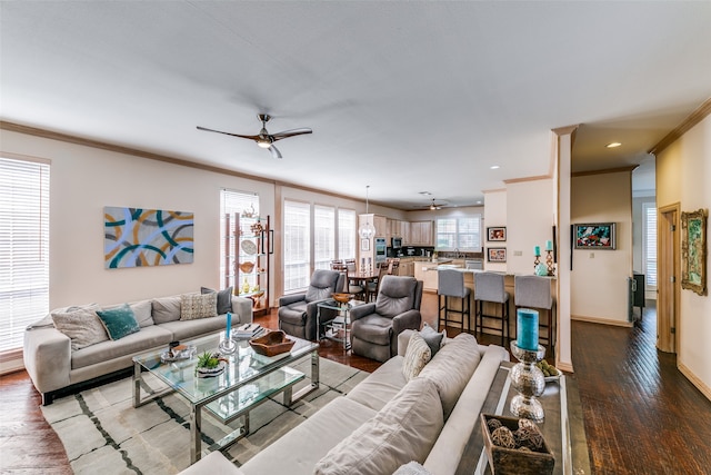 living room with wood-type flooring, ceiling fan, and crown molding