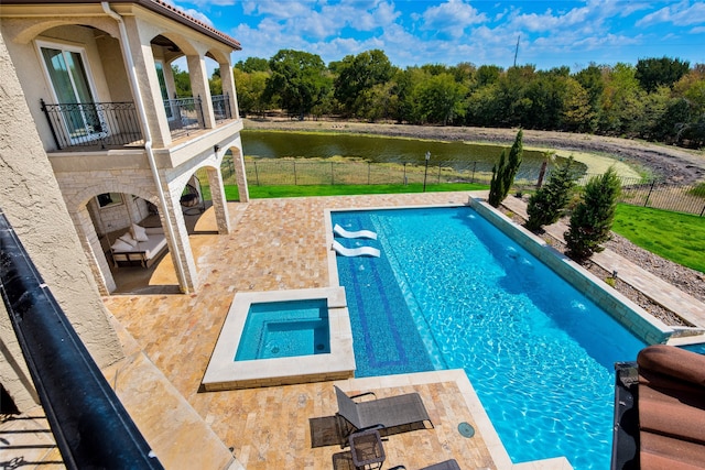 view of swimming pool featuring pool water feature and a patio area