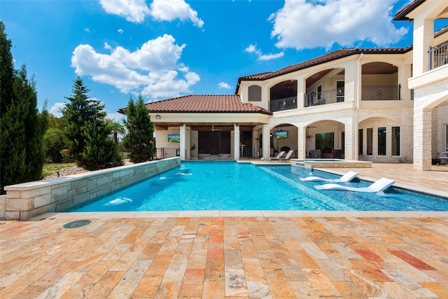 view of swimming pool with an in ground hot tub and a patio