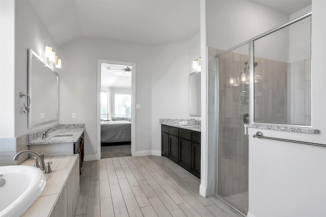 bathroom featuring ceiling fan, vanity, lofted ceiling, and plus walk in shower