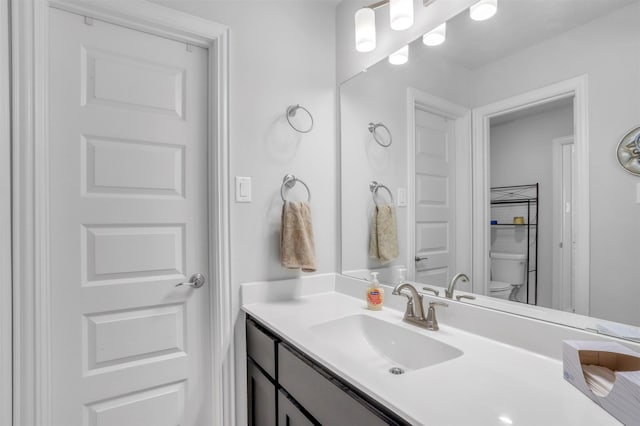 bathroom featuring toilet and vanity