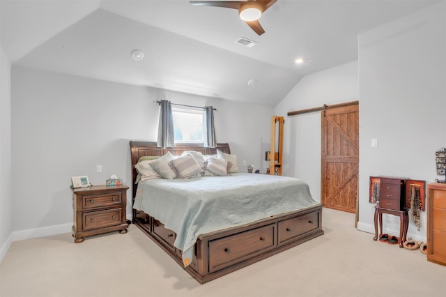 carpeted bedroom with ceiling fan, a barn door, and lofted ceiling