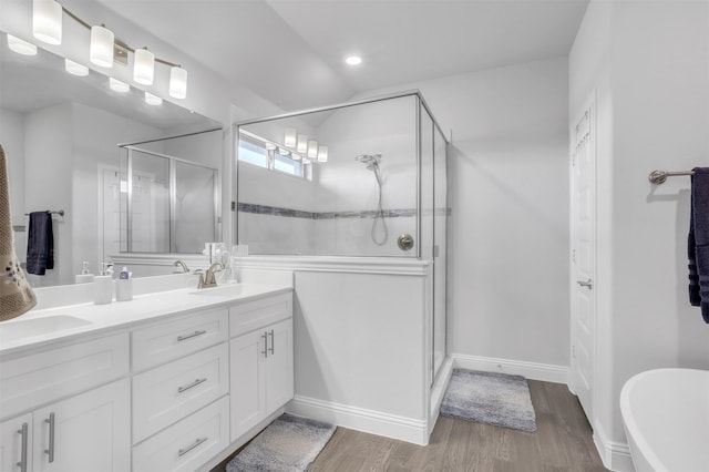 bathroom featuring vanity, hardwood / wood-style floors, and a shower with door