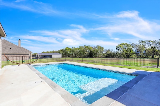 view of pool featuring a lawn and a patio