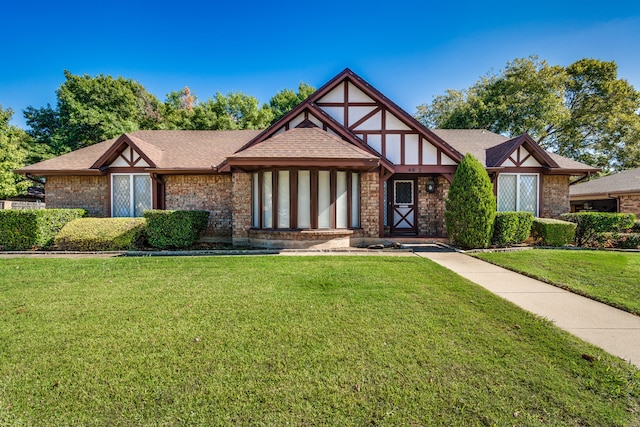 english style home with a front lawn