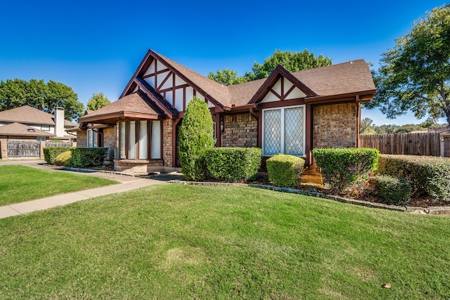 tudor-style house with a front yard