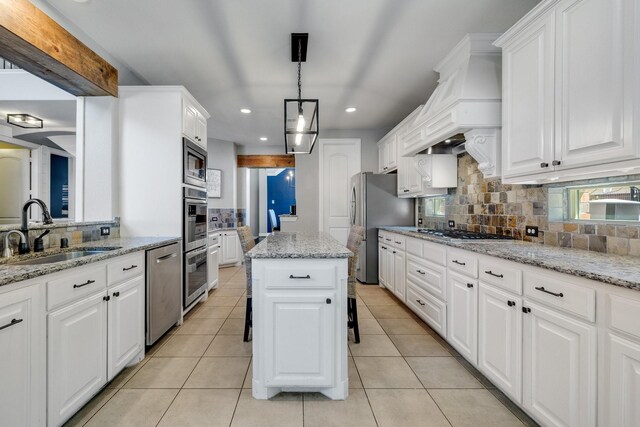 dining space featuring sink and light tile patterned floors