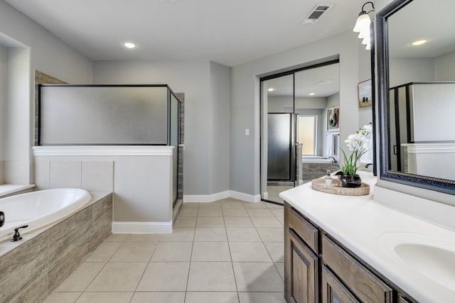 bathroom featuring vanity, tile patterned flooring, and plus walk in shower