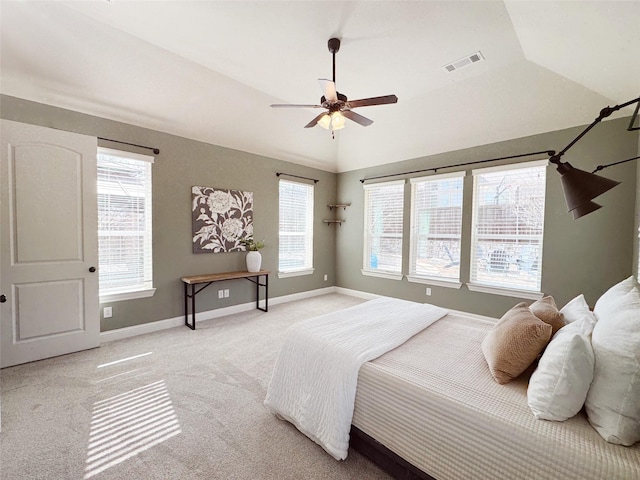 bedroom with baseboards, visible vents, vaulted ceiling, and light colored carpet