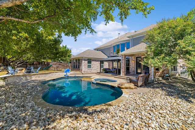 view of swimming pool with a gazebo, a patio area, and an in ground hot tub