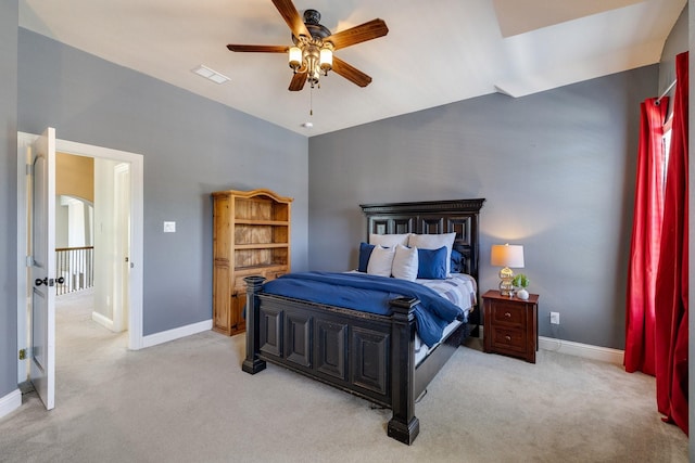 bedroom with baseboards, visible vents, a ceiling fan, and light colored carpet