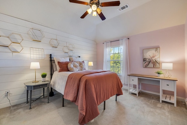 bedroom with visible vents, baseboards, a ceiling fan, carpet flooring, and wood walls