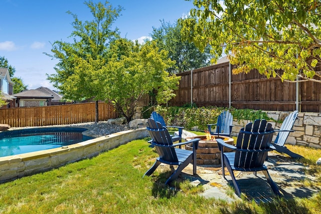 exterior space with a fenced in pool, a fenced backyard, and a fire pit