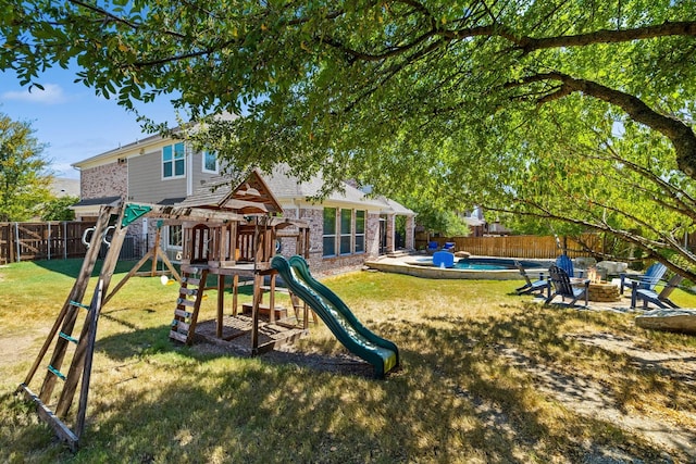 view of playground with an outdoor fire pit, a fenced backyard, and a yard