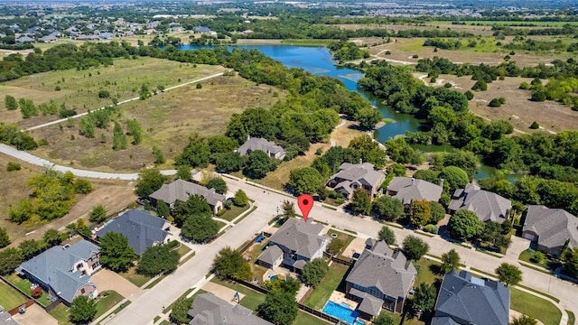 birds eye view of property featuring a water view and a residential view