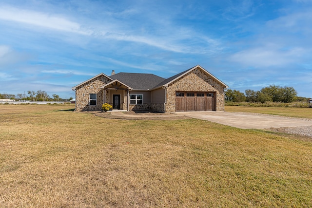 view of front of house featuring a garage and a front yard