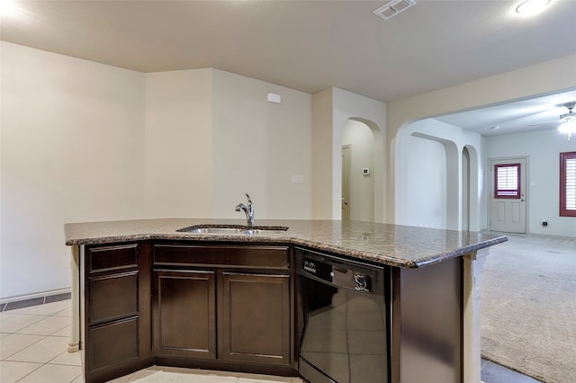 kitchen with light carpet, dark brown cabinetry, sink, and black dishwasher