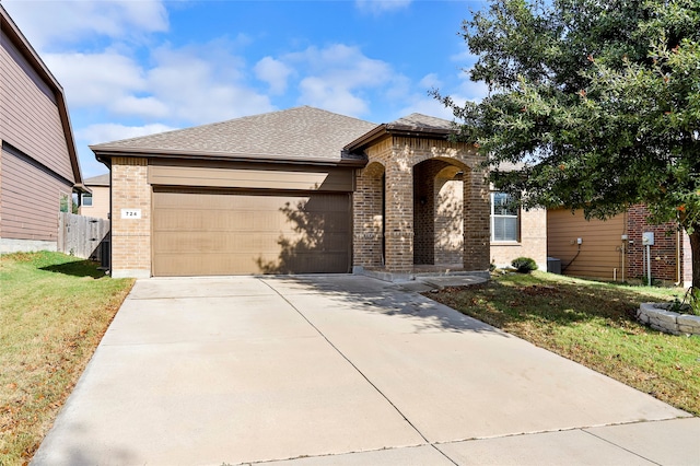 view of front of house featuring central AC unit, a garage, and a front yard