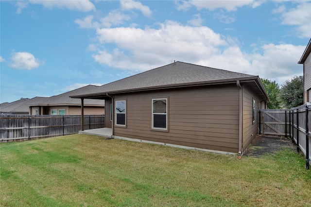 rear view of property featuring a lawn