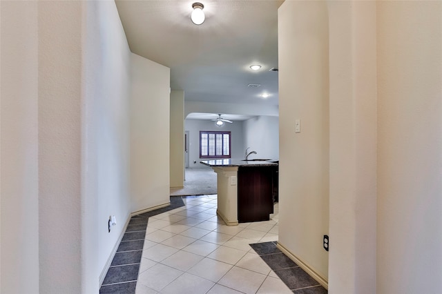 hall with light tile patterned floors