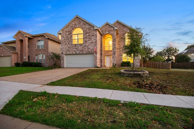 front facade featuring a garage and a lawn