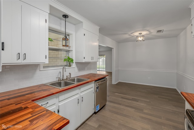 kitchen with wood counters, sink, pendant lighting, and appliances with stainless steel finishes