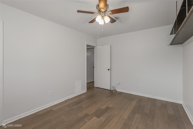 unfurnished room with ceiling fan and dark hardwood / wood-style floors