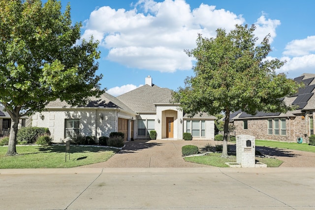 12141 Indian Creek Dr, Fort Worth, TX 76179 - view of front of house with driveway, a garage, a front yard, and a chimney