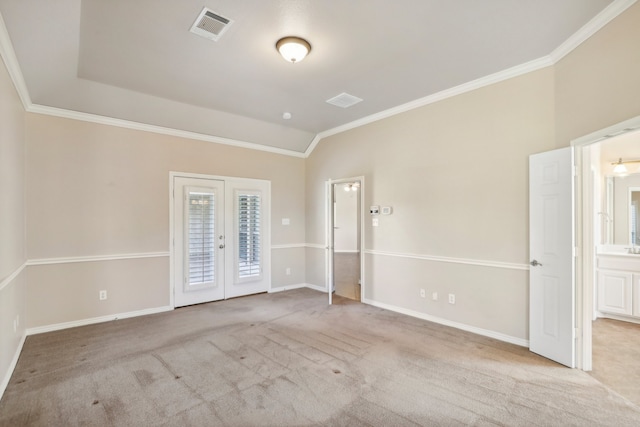 carpeted empty room featuring french doors, lofted ceiling, and ornamental molding