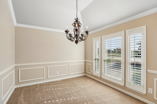 carpeted spare room with ornamental molding and a chandelier