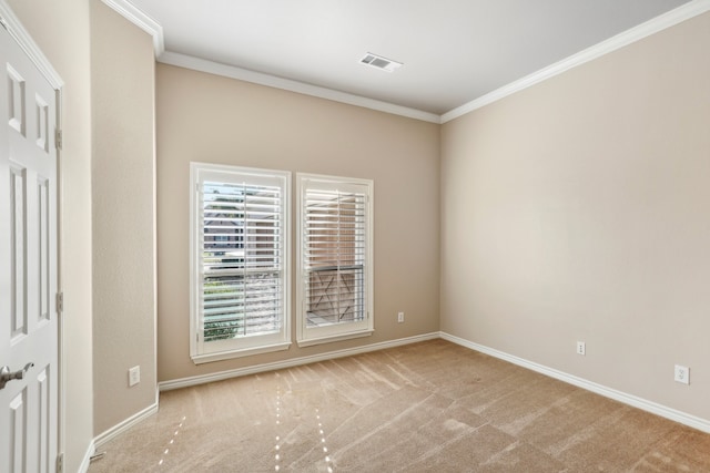 carpeted spare room with crown molding